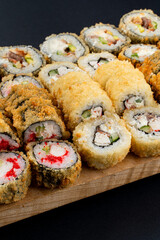 Close up macro shot of crispy fried rolls with crab, shrimp and caviar, advertisement shot