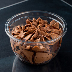 Fluffy chocolate pudding in a plastic take away cup
