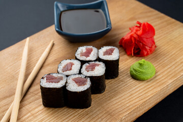 Tuna sushi served on wooden dish, soft studio photo for a menu
