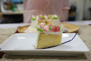 Buttercream cake is cut and placed on a plate.