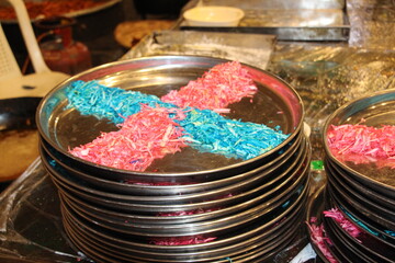 pink and blue food in a frying pan