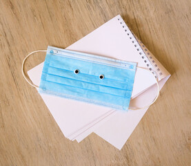 Funny face made of eyes and medical mask, open notepad, covid-19 coronavirus new normal concept,...