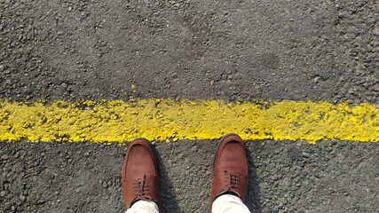 Vintage leather shoes are perfect for traveling.  Start traveling from the yellow line on the side of the road.