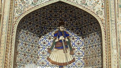 painting of a guard in a niche at the entrance to city palace in jaipur
