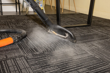 Steam carpet cleaning. Professional Carpet war, water extraction 