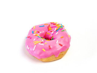Strawberry flavoured donut with sprinkles on white background. One pink doughnut isolated picture. Homemade bakery concept.