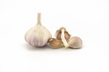 Garlic bulbs and cloves in close-up on white