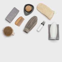 Spa still life background. Set for body care on white. Bottles with gel or shampoo, soap, wooden comb, washcloth for bath.