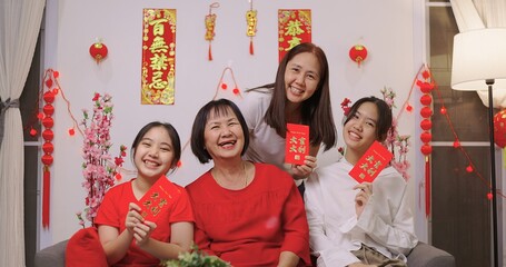 Happy Asian Multi Generations Family Celebrating Chinese New Year. (Foreign Texts Mean Congratulations, Wealth, Good luck, Good Fortune, Spring)