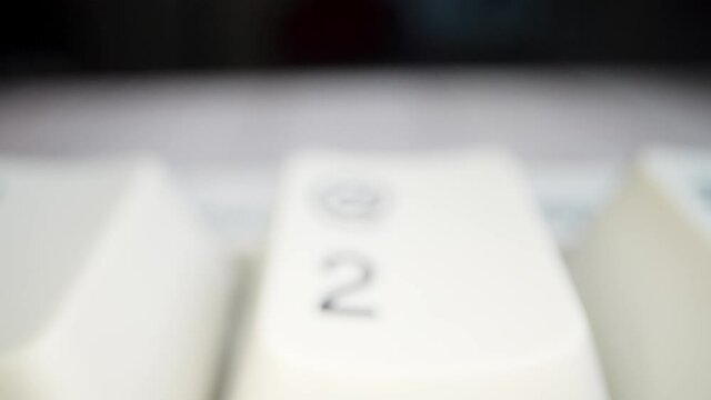 White keyboard keys. Camera movement from left to right. Macro photography.
