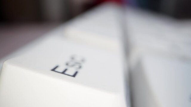 White keyboard keys. Camera movement from left to right. Macro photography.