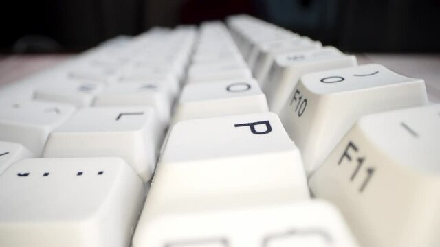White keyboard keys. Camera movement from left to right. Macro photography.