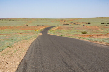 Road through the far south western Queensland desert just after rain.