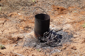 Charcoal Australian billy can boiling water for the morning cuppa.