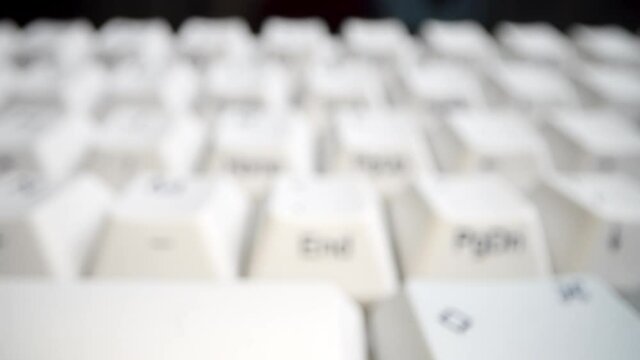 White keyboard keys. Camera movement from left to right. Macro photography.