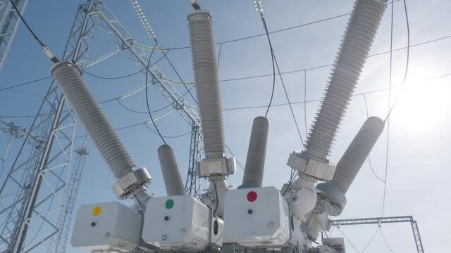 High-voltage power equipment. Action. Latest transformers at substations for production of high electricity. Electric substation with transformers on background of sunny sky