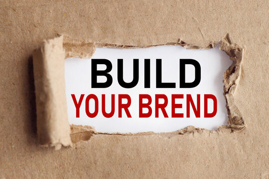 build your brend, TEXT ON WHITE PAPER ON RIPPED PAPER BACKGROUND