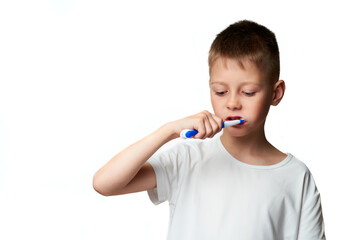 Cute little boy brushes his teeth with toothpaste and a brush