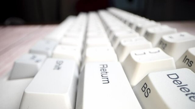 White keyboard keys. Camera movement from left to right. Macro photography.
