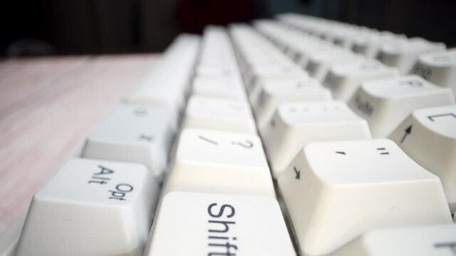 White keyboard keys. Camera movement from left to right. Macro photography.