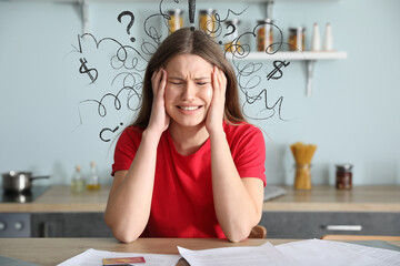 Fototapeta premium Worried young woman in debt at home