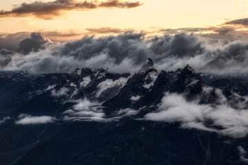 Aerial view of the rugged Canadian landscape of the mountain peaks. Taken near Chilliwack, East of Vancouver, British Columbia, Canada. Dramatic Sunset Sky Art Render