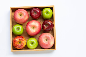 Fresh apples in wooden box on white background.