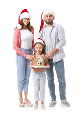 Happy family with gingerbread house on white background. Christmas celebration