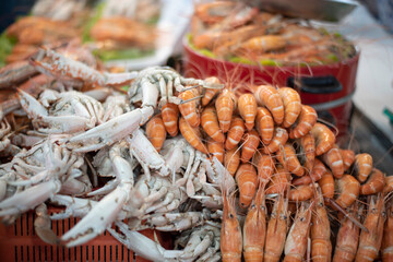 Streamed shrimp and seafood on the street market with soft focus and noise.