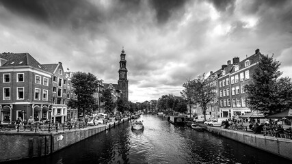 Black and White Photo of the Westertoren tower seen from the intersection of the Leliegracht and Prinsengracht canals in the Jordaan neighborhood