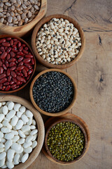 assortment of beans on wooden surface