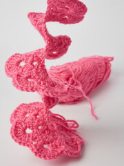 Needlework crochet, top view of yarn balls, flat spoon on light wood close-up