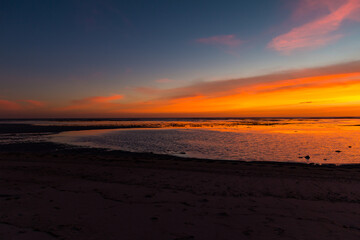 Fototapeta na wymiar Red burning sunset sky view at the seashore in Indonesia