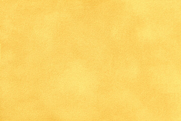 Yellow matte background of suede fabric, closeup. Velvet texture of textile