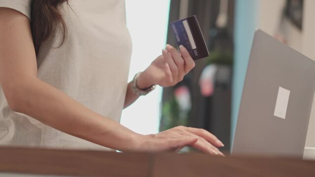 customer woman hand using computer laptop for online shopping. pay with credit card. e-commerce concept