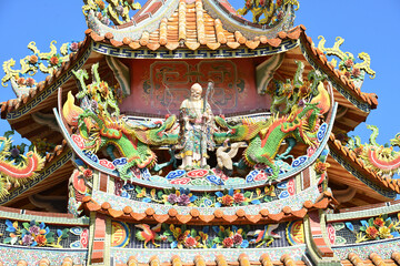 Chinese traditional temple roofs .bright multi-colored sculptures of Chinese god on the roof