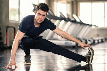 Fototapeta premium Handsome man exercise workout in gym fitness breaking relax and warm up with dumbbell for bodybuilding.