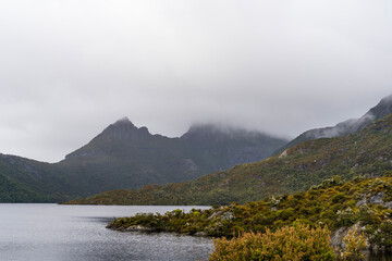 Cradle Mountain hiding behind the clouds on a rainy day - Cradle Mountain National Park, Tasmania, Australia.
