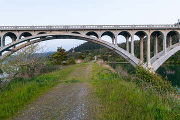 A gravel road runs under the Rogue River Bridge at Gold Beach, Oregon, USA