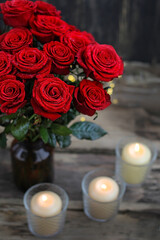 beautiful still life with bouquet of red roses and candles. love symbol, Valentine's day, 14 february romantic concept.