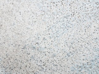 Cracked cement texture in light grey earth tone for background. Close up image of raw grunge surface material.