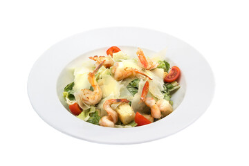 Seafood Caesar salad with shrimp, arugula, and parmesan cheese on a round white plate. Close-up.