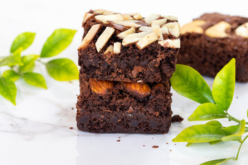 dessert snack brownies with leaf arrangement flat lay style on background white
