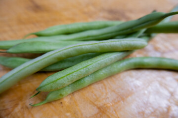 Green beans isolated on a scratched wooden table