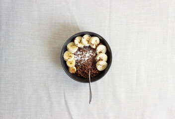 Porridge with banana isolated on  textured background. Oatmeal. Healthy lifestyle. Ketogenic diet. Dessert. Meal.