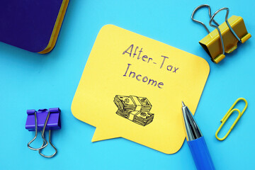 Financial concept meaning After-Tax Income with sign on the sheet.