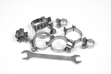 metal clamps for repairing hose connections and a wrench