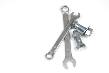 several metal bolts and nuts with wrenches on a white background