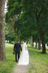 Newlyweds. Wedding. The newlyweds are walking.Lovers hold hands.