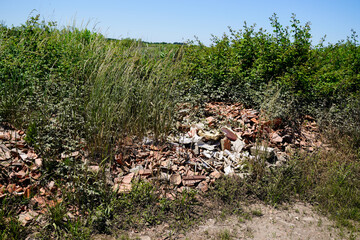 Naklejka na ściany i meble wild waste depot from construction site in natural area